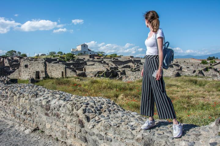 a person standing in front of a rock